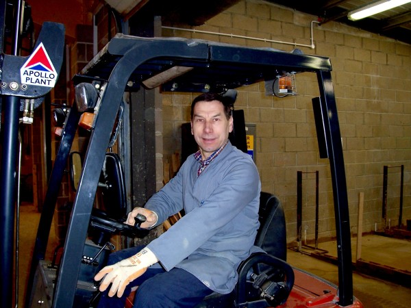 Brian driving a new forklift truck purchased for the construction department around 2002.